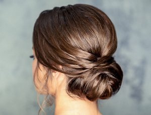 Woman with her hair styled in a loose, elegant chignon